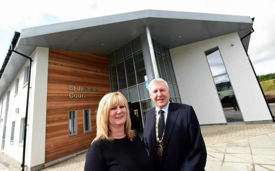 Inspire chief executive Karen Arthur and Aberdeenshire Provost Hamish Vernal standing in front of St James Court in 2015.