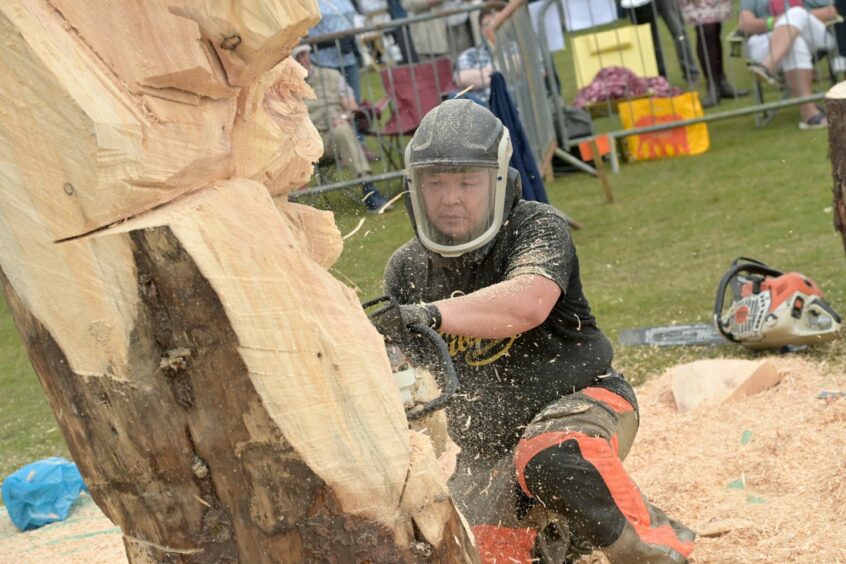 Another view of Lkhagvadorj Dorjsuren working on his piece for this year's Scottish Open Chainsaw Carving Competition.