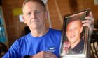 CR0044773
Stuart Findlay,
Inverness.
Patrick and Wendy Mullery of Cromarty lost their son James to suicide in 2017. 
Patrick is photographed at home with a photograph of James.
Sandy McCook/DC Thomson