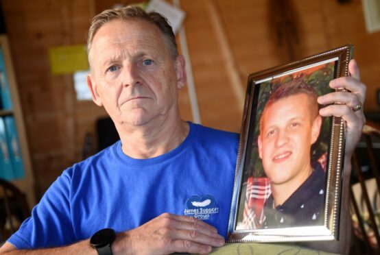 CR0044773
Stuart Findlay,
Inverness.
Patrick and Wendy Mullery of Cromarty lost their son James to suicide in 2017. 
Patrick is photographed at home with a photograph of James.
Sandy McCook/DC Thomson