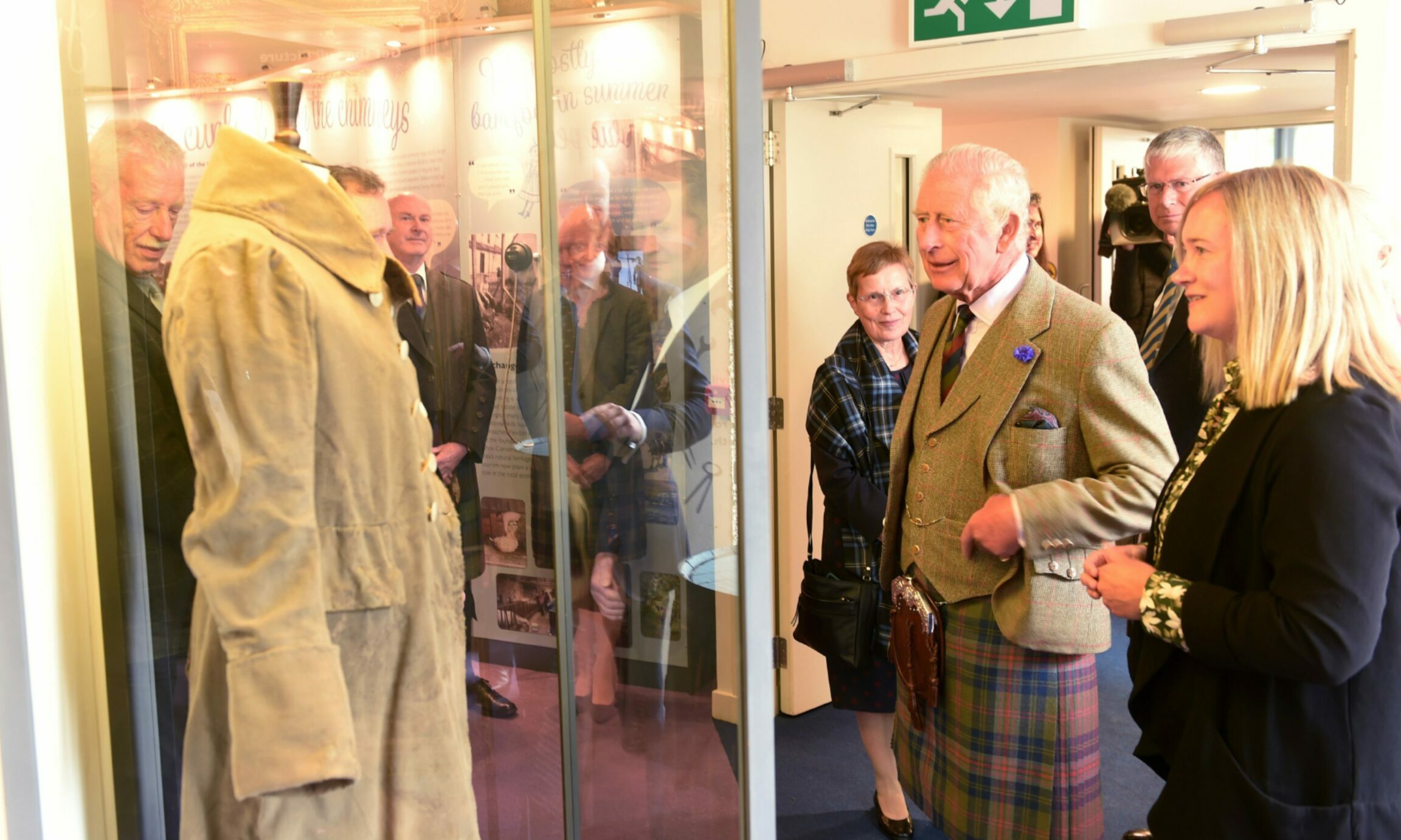 King Charles inspects the Tomintoul Coat inside the Tomintoul and Glenlivet Discovery Centre. 