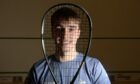 Alasdair Prott, who is preparing for the Squash Scottish Open, looking through his racket