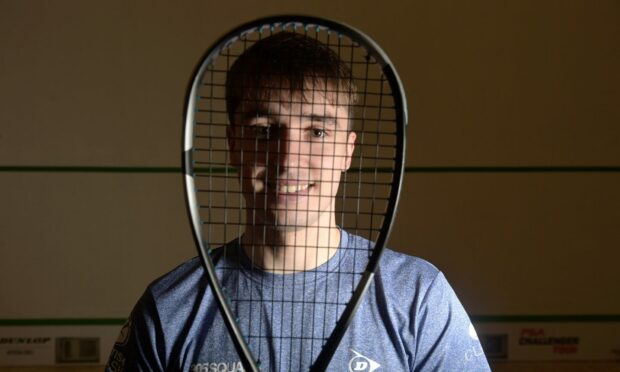 Alasdair Prott, who is preparing for the Squash Scottish Open, looking through his racket
