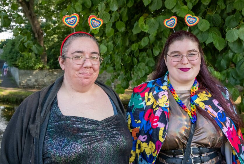 Two revellers don headgear with rainbow hearts for the Moray Pride event.