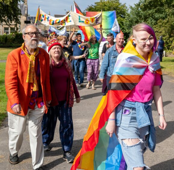Moray Pride 2023 attendees marching across the town.
