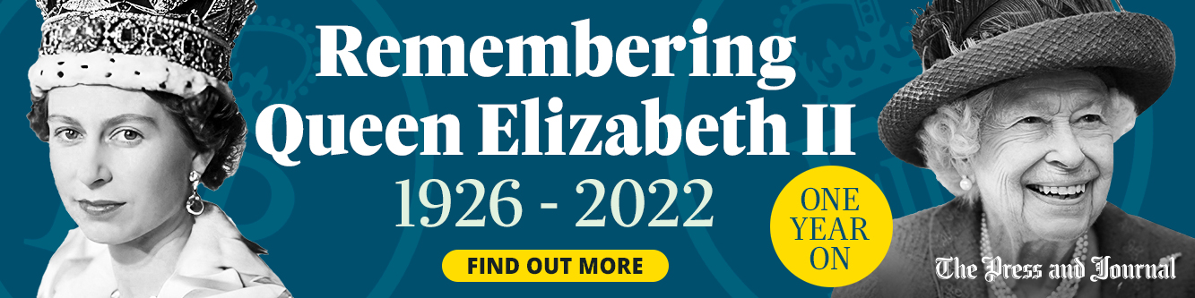 Memorial banner for Queen Elizabeth II featuring photographs from her youth and later years, along with tribute text marking the first anniversary of her death: 'Remembering Queen Elizabeth II: One year on, 1926-2022'.