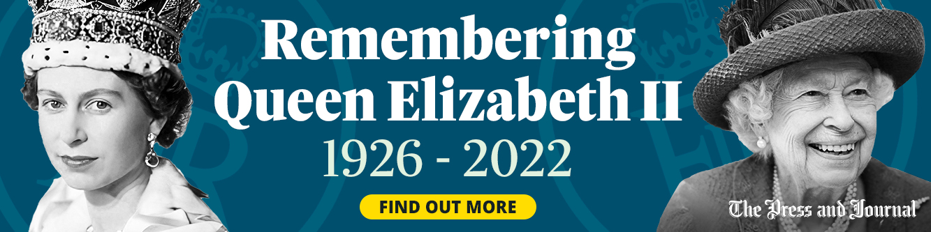 Memorial banner for Queen Elizabeth II featuring photographs from her youth and later years, along with tribute text marking the anniversary of her death: 'Remembering Queen Elizabeth II, 1926-2022'.