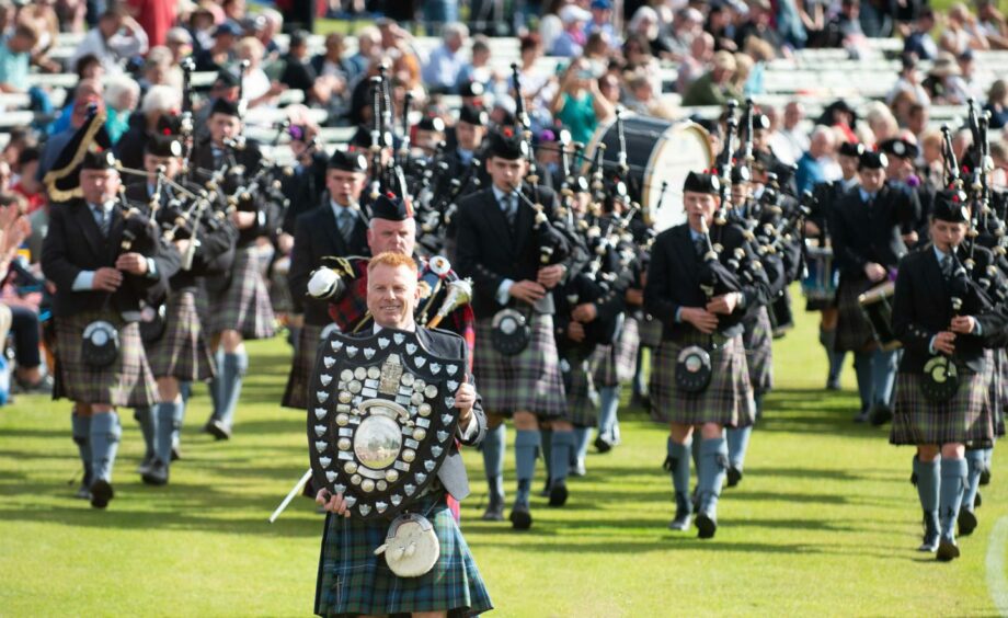 Pipers, including one with the shield.
