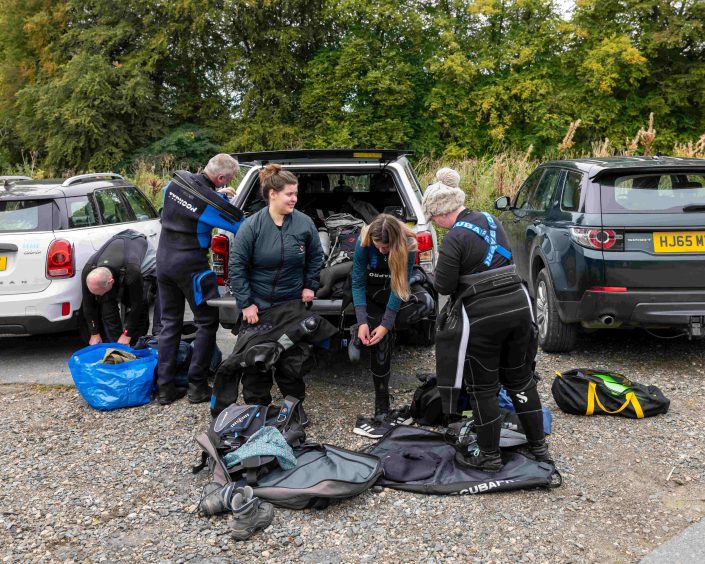 Volunteers get into their gear ahead of the search