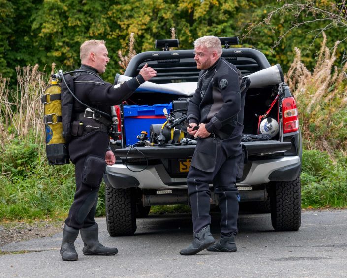 Two divers getting into their gear before starting a search of the River Don near Monymusk