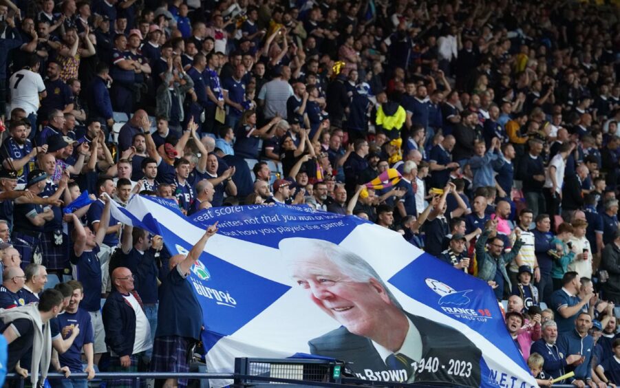 Fans in the stands holding a giant banner paying tribute to former Scotland manager Craig Brown