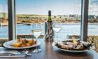 table setting at the Silver Darling restaurant with a view of Aberdeen's harbour and beach