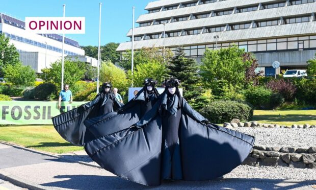 Extinction Rebellion protesters demonstrate at the former Shell Tullos offices in Aberdeen during 2022 (Image: Kami Thomson/DC Thomson)