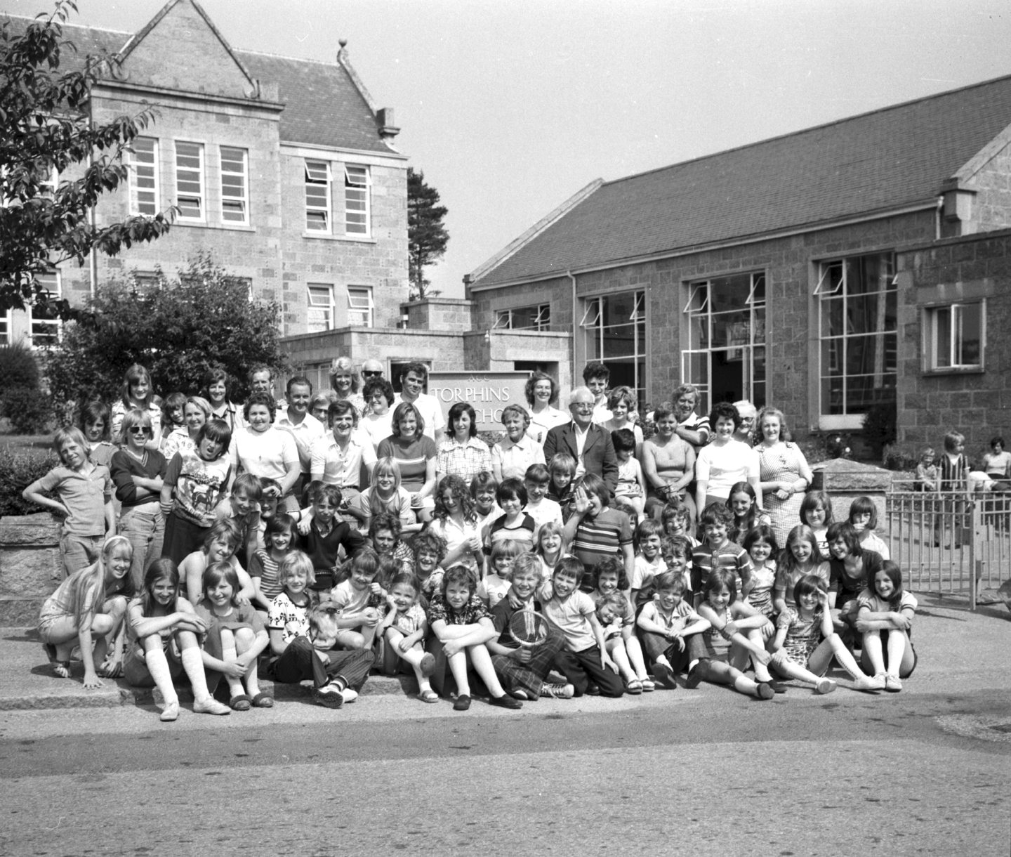 Mums and dads join the Walker Road School children for a souvenir picture outside Torphins School at Walker Road School's camp in July 1976. 