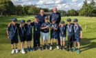 Dave Walker and Duncan Stewart standing with a group of Inverurie golf club juniors