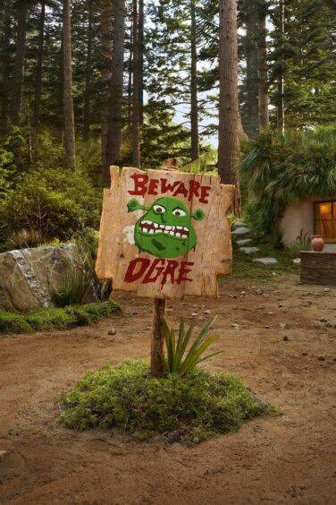 A Beware Ogre sign at Shrek's Swamp for rent on Airbnb.