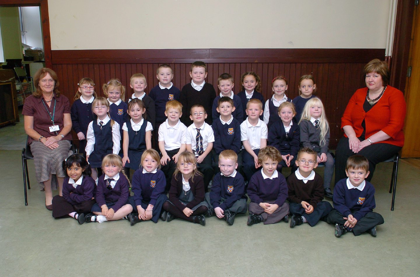 Teacher Mrs Mavor and Mrs Massie, pupil support assistant, and their new P1 class.