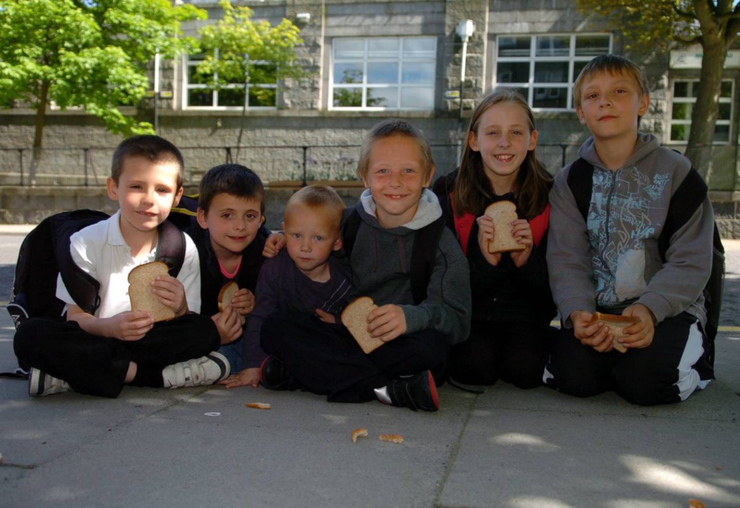 Pupils smile for a photo during breaktime in 2010.
