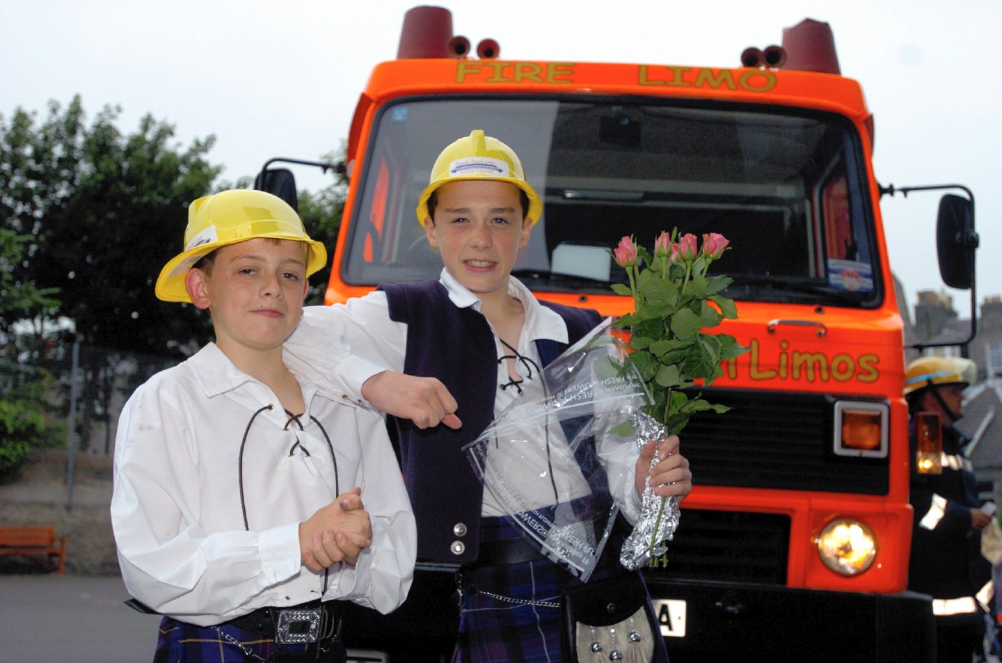 Jamie Moor and Keith Morrison in front of the fire engine they arrived to the Walker Road prom in in 2005.