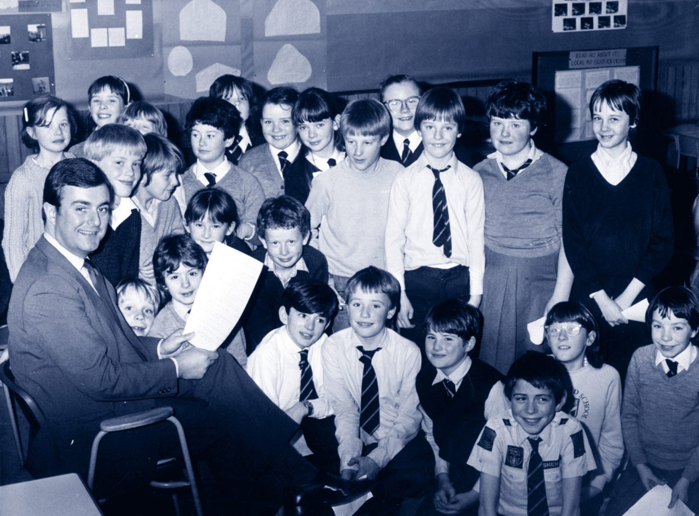 As part of the school's own Question Time in 1984, South Aberdeen MP Gerry Malone holds up the list of questions which were asked by pupils of Primary 6 about a BMX cycle track for the city. 