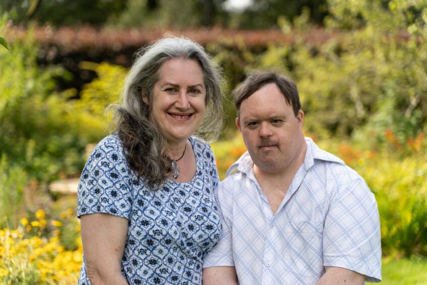 Deanne Latham and her brother Gavin Henderson, who has Down's syndrome, standing outside in a garden