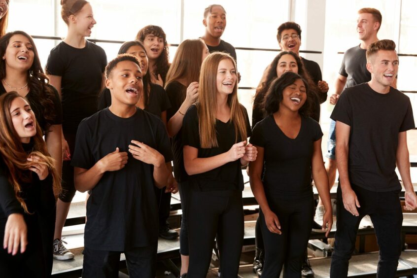 Group of young people singing in a choir.