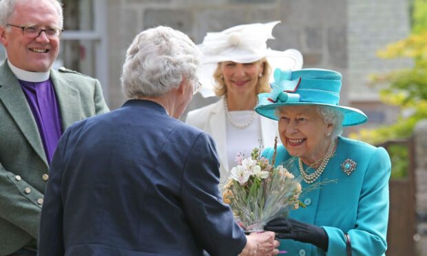 Queen Elizabeth II and Rev Kenneth MacKenzie at Crathie Kirk.