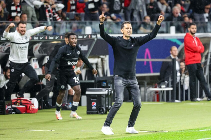 Eintracht Frankfurt manager Dino Toppmoller with his arms in the air on the side of the pitch