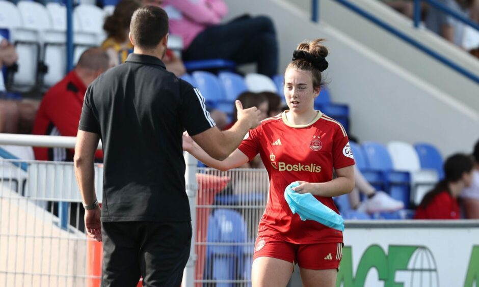 Aberdeen Women defender Madison Finnie goes to shake hands with manager Clint Lancaster.
