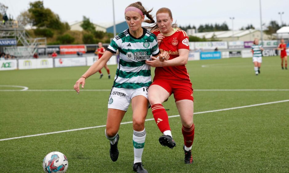 Aberdeen's Hannah Stewart battles with Celtic's Caitlin Hayes in a SWPL match at Balmoral Stadium.
