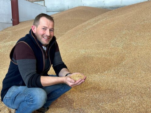 Arable manager Sandy Norrie with the winning crop of Tapestry winter wheat.