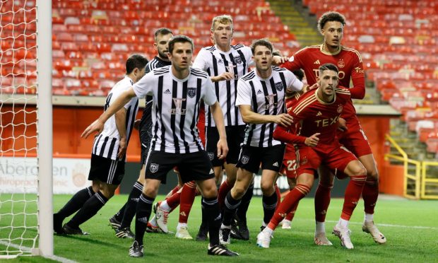 Aberdeen and Fraserburgh players battle for possession in the Aberdeenshire Shield at Pittodrie. Image: Shutterstock.