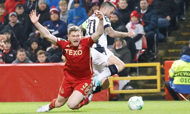 Aberdeen's Jack MacKenzie goes down in the box and appeals for a penalty against PAOK. Image: Shutterstock.