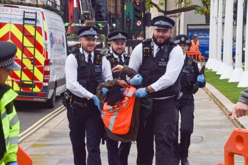 Police officers arrest dozens of Just Stop Oil activists in Parliament Square, London. 