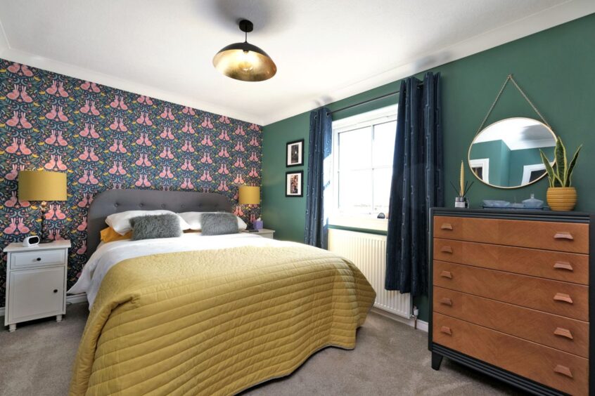 One of the bedrooms in the renovated home near Stonehaven, featuring vibrant wallpaper and decor.