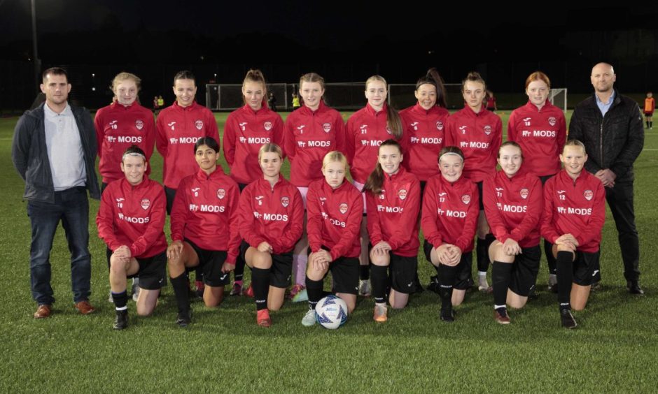 Aberdeen FC Ladies U-16s with, left, Scott Smith, and Tim Bell, chief product officer and chief customer support officer respectively at Mods. 