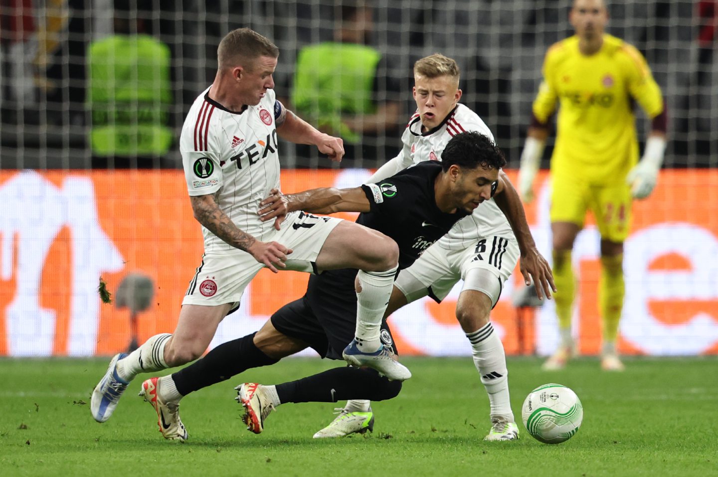 Aberdeen's Jonny Hayes and Connor Barron against Frankfurt's Fares Chaibi during the Europa Conference League Group Stage match.