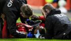Aberdeen striker Duk  down after a head knock during the Europa Conference League match between Aberdeen and HJK Helsinki at Pittodrie Stadium. Image: SNS.