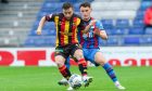 Caley Thistle's Cammy Harper keeps a close watch on Partick Thistle's Steven Lawless. Image: Craig Brown/SNS Group