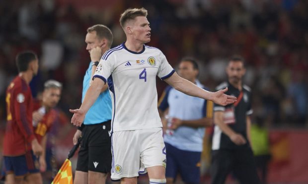 Scotland's Scott McTominay looks dejected as his goal in Spain is checked by VAR. Image: SNS.