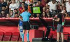 Referee Serdar Gozubuyuk checks VAR for a foul after Scott McTominay's free kick for Scotland