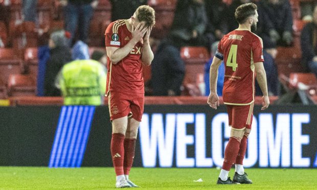 Aberdeen's Nicky Devlin looks dejected at full time after losing 3-2 to PAOK in Europa Conference League Group G. Image: SNS