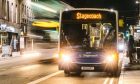 Stagecoach bus on Union Street in the dark with lights on