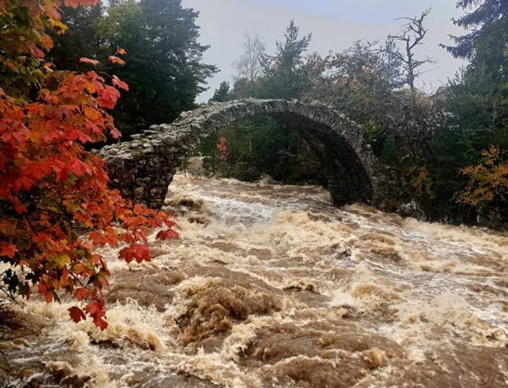 Flooding through Carrbridge in the Highlands via the River Spey.