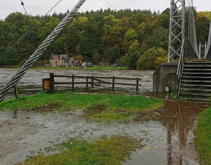 The overflowing River Spey burst its banks with floodwater soon filling Alice Littler Park nearby.