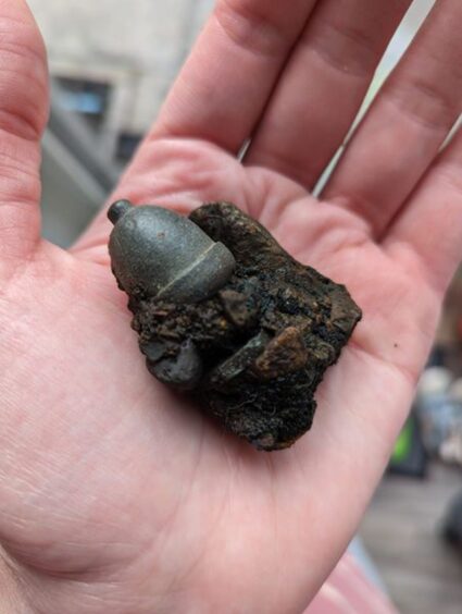 The object was found on a beach near Oban. It is acorn shaped and covered in metal. 