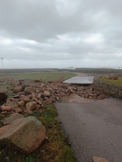 Destroyed road at Boddam Harbour following Storm Babet.