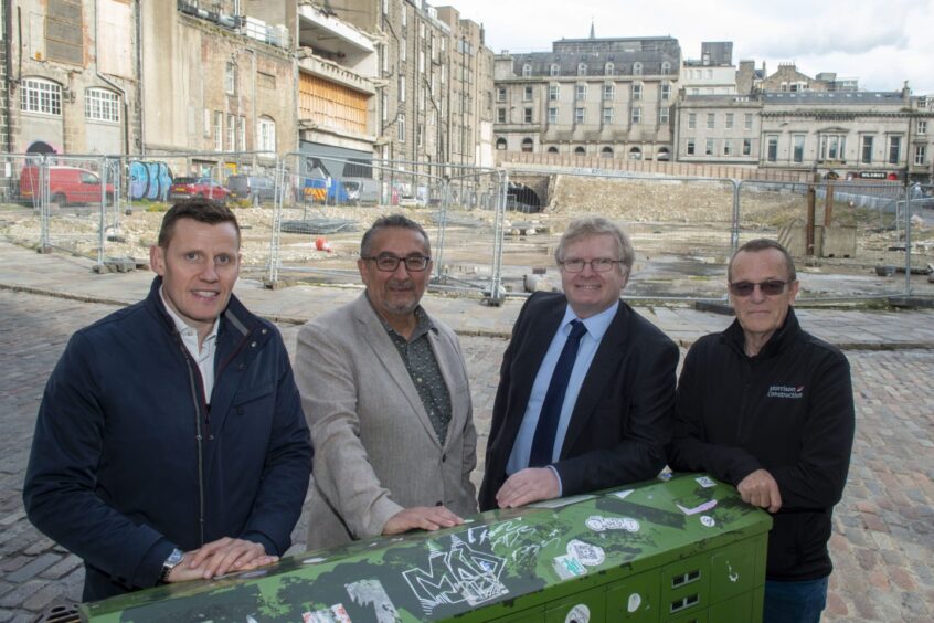 Richard Park, the chief executive of council partner Hub North Scotland, council co-leaders Christian Allard and Ian Yuill and Colin Milne, project director for Morrison Construction at the currently demolished site where Aberdeen market will be built. Image: Aberdeen City Council