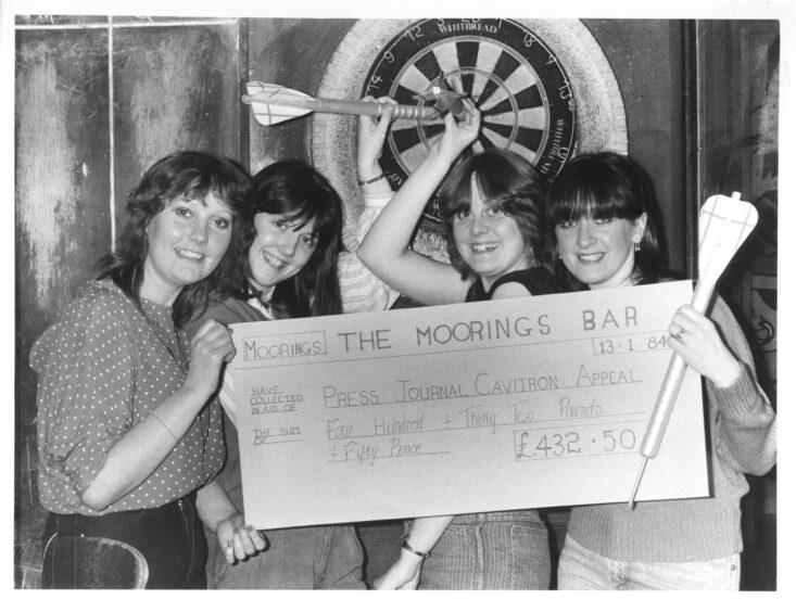 The Moorings Bar staff pose with their Cavitron appeal cheque.