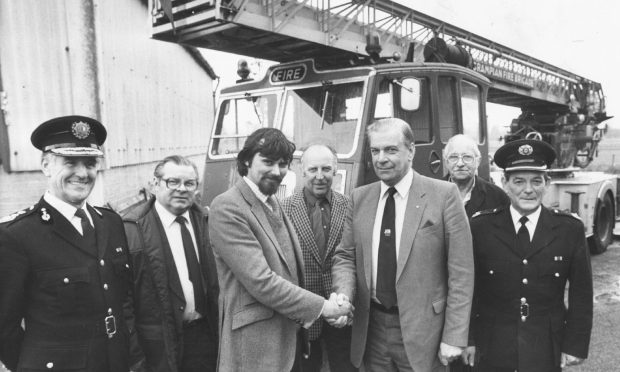 1988: Transport museum curator Mike Ward, centre left, took delivery of Grampian Fire Brigade's faithful old 1955 Dennis turntable-ladder engine from Councillor James McPherson.